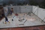 Over half of concrete walls are set on the concrete base of the house